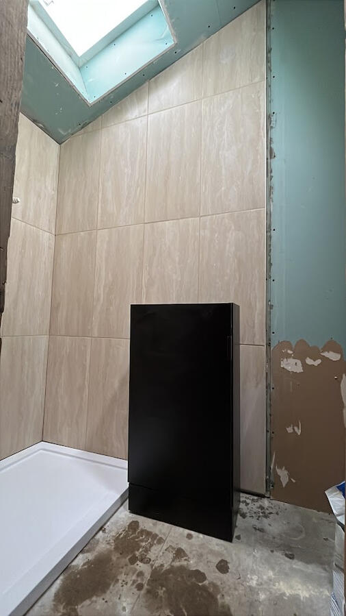 Shower enclosure tiled and grouted before remaining walls and ceiling taped and seamed Tiling in shower