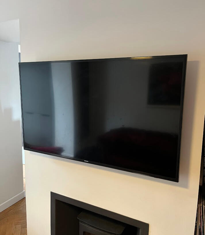 TV mounted on wall above wood burner TV mounted on wall above wood burner